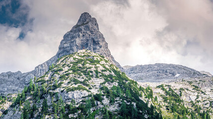 View to the high Berchtesgaden mountain peaks with cloudy sky at the background