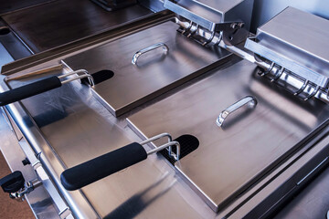 Restaurant kitchen with chrome equipment. Fast food cuisine.