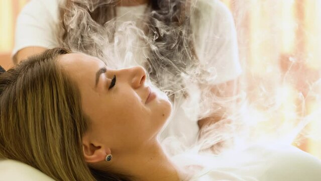 Woman Exhaling Smoke from Electronic Cigarette