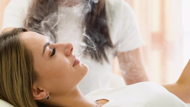 Woman Exhaling Smoke from Electronic Cigarette