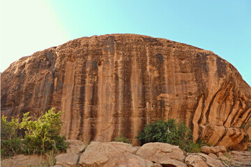 Colorful brown mountain rock with green trees