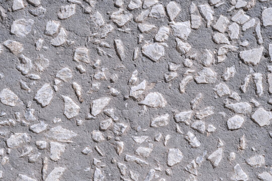 Background and texture of th surface is made of concete and small stones.