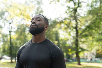 Portrait of athletic man standing in park