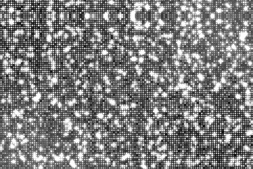 Black and white background with small square dots and shiny particles.