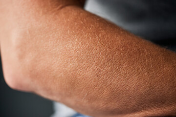 Close-up of a middle-aged man's hand skin, looking hydrated after putting on moisture.