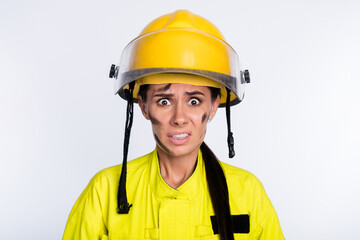 Photo of young woman firefighter afraid scared shocked terrified dangerous isolated over white color background