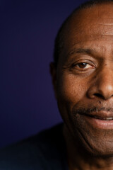Portrait of smiling man against purple background