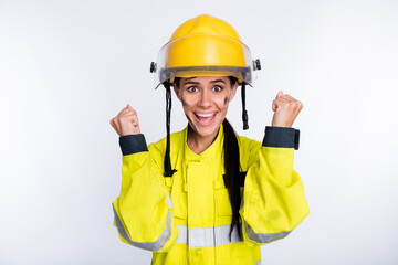 Photo of young attractive woman firefighter happy positive smile rejoice win victory fists hands isolated over white color background