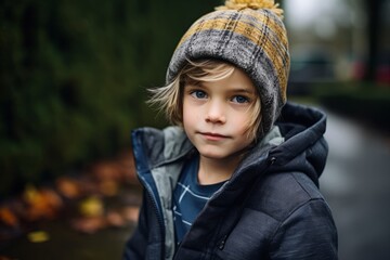 Portrait of a cute little boy in a knitted hat and jacket