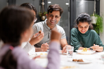 Family dining at home in evening