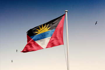 Antigua and Barbuda flag fluttering in the wind on sky.