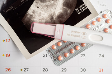 Pregnancy test and birth control pills with ultrasound scan of baby uterus, contraception health...