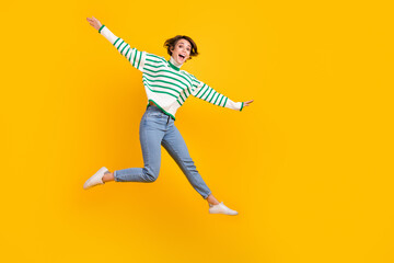 Fototapeta na wymiar Full body length size photo crazy youngster girlfriend jumping flying arms wings having fun careless isolated on yellow color background