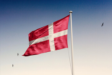 Denmark flag fluttering in the wind on sky.