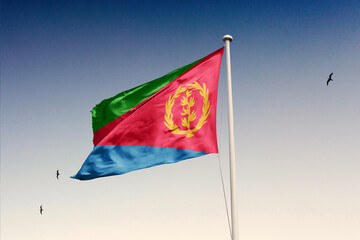 Eritrea flag fluttering in the wind on sky.