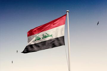 Iraq flag fluttering in the wind on sky.