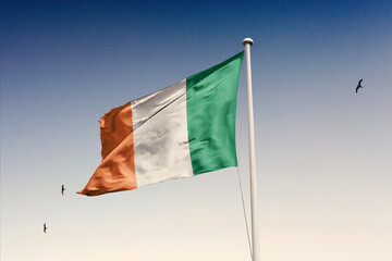 Ireland flag fluttering in the wind on sky.