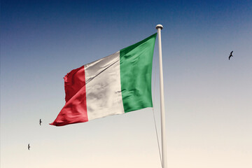 Italy flag fluttering in the wind on sky.
