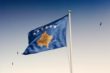 Kosovo flag fluttering in the wind on sky.