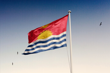 Kiribati flag fluttering in the wind on sky.