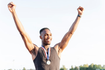 Portrait of athlete celebrating with medal