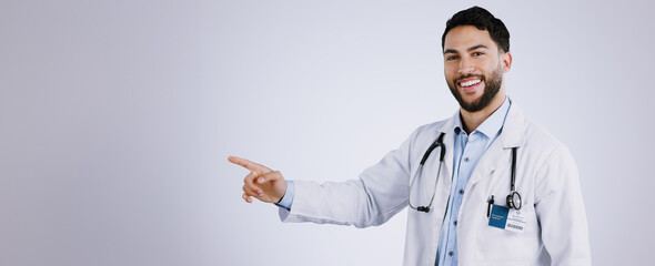 Portrait, smile and doctor pointing at presentation, mockup or space on a white background. Face,...