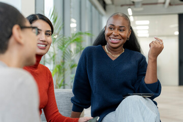 Coworkers having meeting in office lobby