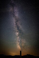 Stunning long exposure of the Milky Way seen from the Austrian alps. Bluish magenta tone astro...