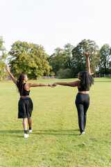 Young female friends walking in park after exercising