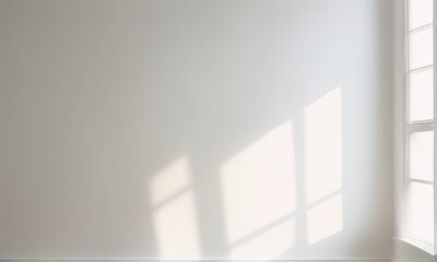 A white wall with warm light from the window