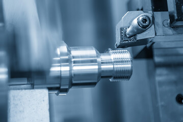 Close up scene the CNC lathe machine thread cutting at the end of metal pipe parts.