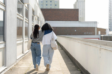 Young female couple walking in city - obrazy, fototapety, plakaty