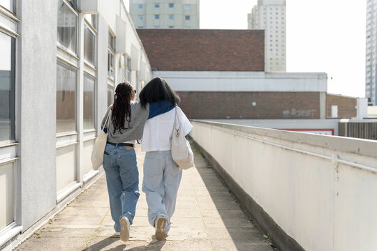 Young Female Couple Walking In City