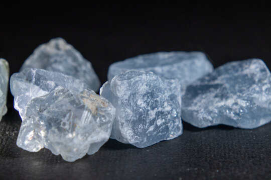 Rocks of rough natural celestite isolated in the dark background