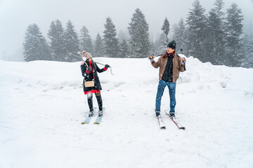 Asian tourist couple on ski and snow of Sonmarg Valley in Himalayas during winter Christmas trip,...