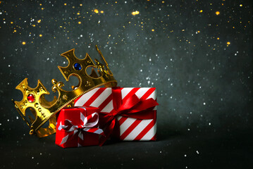 Crown of the three wise men with Christmas gift boxes and christmas lights. Concept for Dia de...