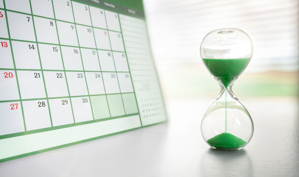 Hourglass and green calendar