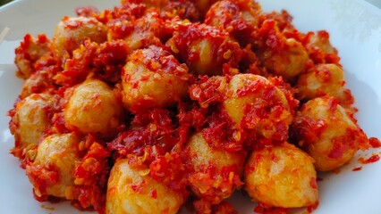 Hot spicy meatballs on a white plate, close up, bakso mercon, bakso pedas, delicious food