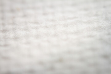 Extreme closeup of white handmade paper with dried plants
