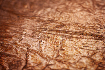 Extreme closeup of crumpled brass foil texture