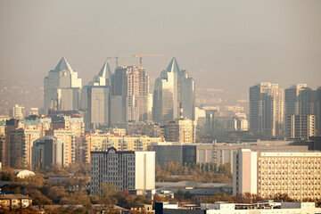View of Almaty from the roof of the house. Heavy smog over the city. Development of the old part of the city.