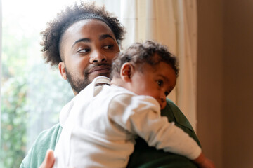 Father holding baby daughter © Cultura Creative