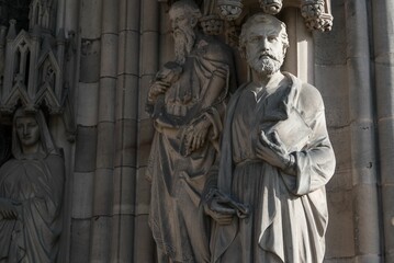 Obraz premium Closeup of intricately carved stone statue mounted above a brick wall in Lichfield Cathedral, UK