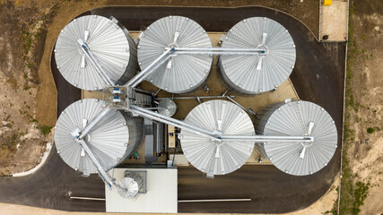 Aerial view of agricultural Silos. Storage and drying of grains, wheat, corn, soy, sunflower. Elevator silos © dechevm