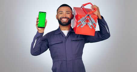 Portrait, handyman and smartphone with green screen, tool box and smile on white studio background. Face, person and model with cellphone, tracking markers and mechanic with mockup space or promotion