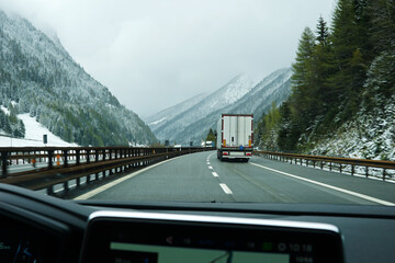 Snowy mountain cliff and cloudy sky with traffic view on Brennero Autostrada motorway to Innsbruck, Medieval old town in the capital of Austria’s western state of Tyrol, Europe