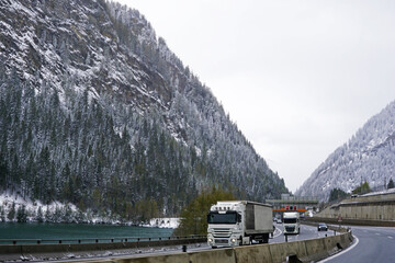 Snowy mountain cliff and cloudy sky with traffic view on Brennero Autostrada motorway to Innsbruck,...