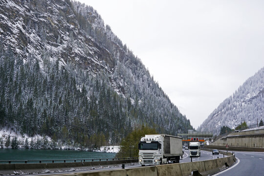 Snowy mountain cliff and cloudy sky with traffic view on Brennero Autostrada motorway to Innsbruck, Medieval old town in the capital of Austria&rsquo;s western state of Tyrol, Europe