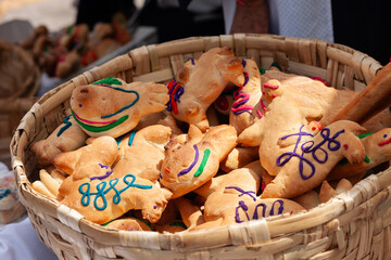 animals made of bread and decorated with colors on a basket during the day of the dead in otavalo ecuador