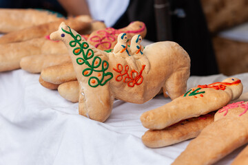 Bread horses decorated with colorful dough for sale during the day of the dead in Otavalo Ecuador